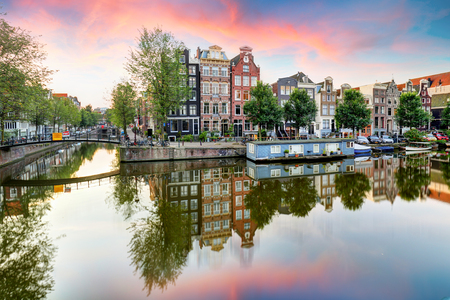 Amsterdam Canal houses at sunset reflections, Netherlandsの写真素材