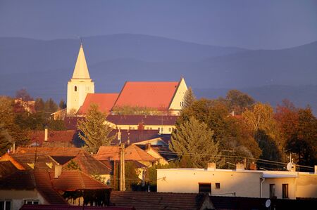 Church in village Senkvice with mountain background at dramatic sunsetの写真素材