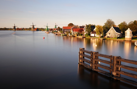 Dutch landscape with windmill at dramatic sunset, Zaandam, Amsterdam, Netherlandsの写真素材