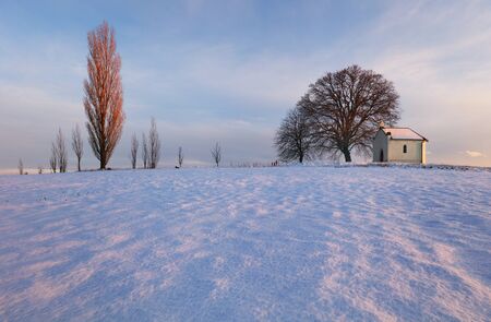 Winter landscape with a beautiful chapelの写真素材