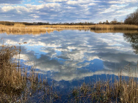 Lake with clouds reflection at spring