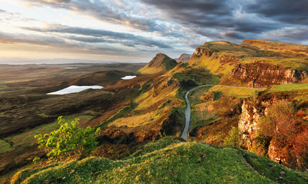 Scotland - Beautiful summer sunrise mountain landscape over the Quiraing and it's steep winding...