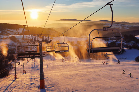 Colorful winter sunset lift ski resort in Krahule mountains in Slovakiaの写真素材