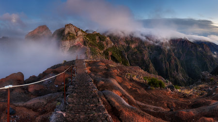 Landscape of sunrise in mountain over clouds in Madeira Island on Pico do Arieiro over steep cliffs...