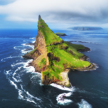 Faroe Islands Vagar, aerial drone view of Tindholmur island during sunset in North Atlantic Ocean. Faroe Islands, Denmark, Europe.の写真素材