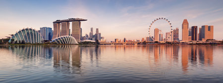Panorama of Singapore city skyline at business modern downtown building area in sunrise with cloud and sun light and reflection architecture on waterのeditorial素材