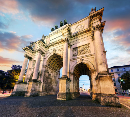 Dramatic sunset over Siegestor - Victory Gate  arch in downtown Munich, Germanyの写真素材
