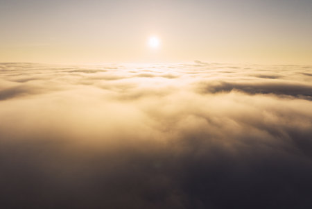 Beautiful sunset cloudy sky from aerial view. Airplane view above cloudsの写真素材