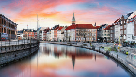 Dramatic sunset over Gammel strand with canal reflection in downtown Copenhagen skyline, Denmarkの写真素材