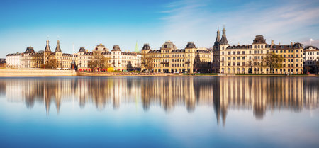 Copenhagen cityscape and Peblinge Lake or Student Lake as seen from Queen Louise Bridge in central Copenhagen, Denmark. Tourists visit and enjoy views of waterfrontの写真素材