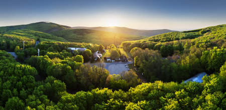 Aerial shot of green hills of Slovakia at sunriseの写真素材