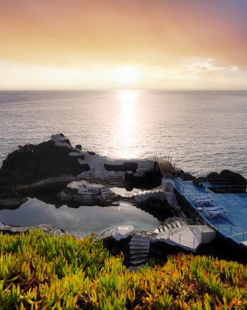 Dramatic sky seascape with rock in sunset scenery background Amazing light nature landscape, Madeira near beach Formosa, Portugalの写真素材