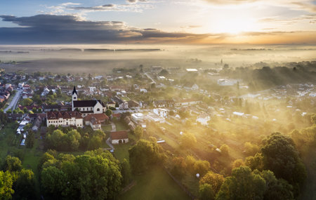 Lovely rural countryside in beautiful sunlight at sunrise with fog. Amazing landscapeの写真素材