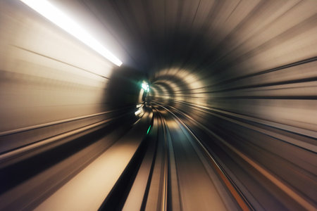 Copenhagen, Denmark. Riding the metro in Copenhagen, Denmark with motion blurred tube lines in tunnel. Abstract with blurred curved linesの写真素材