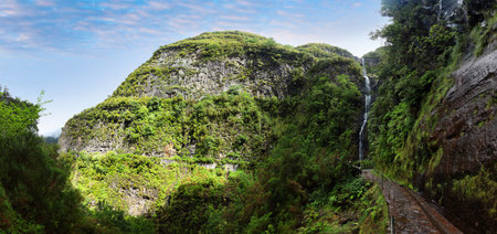 Waterfall Risco with levada in Madeira with green vegetation, Portugalの写真素材