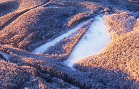 Snow on ski slope at ski resort on a sunny winter dayの写真素材