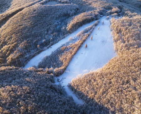 Fantastic sunrise in the mountains. Fresh snow covered slopes and fir trees in Carpathian mountains, Slovakia, Europe. Ski tour on untouched snowy hills. Beauty of nature concept backgroundの写真素材