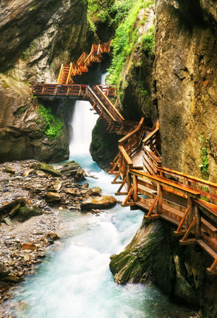 Austria waterfall in Alps, Sigmund Thun Gorge cascade and canyon with river in Kaprunの写真素材