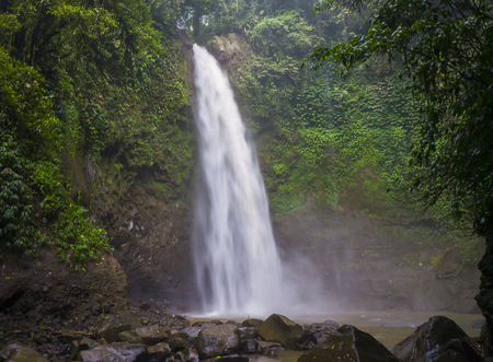 Jungle landscape with flowing turquoise water of Erawan cascade waterfall at deep tropical rain forest. Indonesiaの写真素材