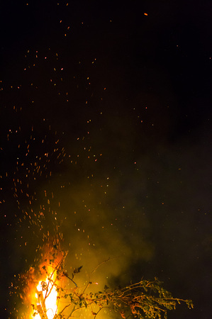 bonfire summer night flames with sparks on a black backgroundの写真素材