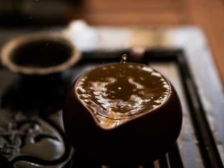 Green Tea Pouring with Drops in Traditional Chinese Tea Ceremonyの写真素材