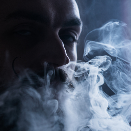 Stoned Man with Beard and Mustages Blows Huge Smoke cloud.
