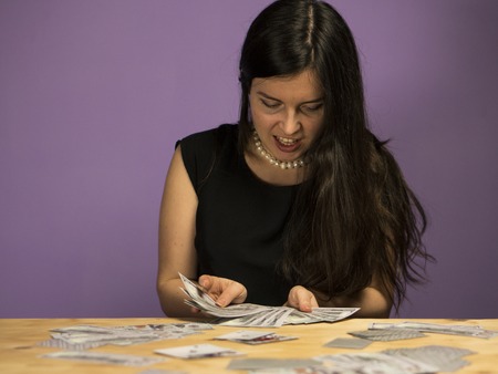 Young woman enjoys the money. Woman shouts of joy, because she won a large sum of money.