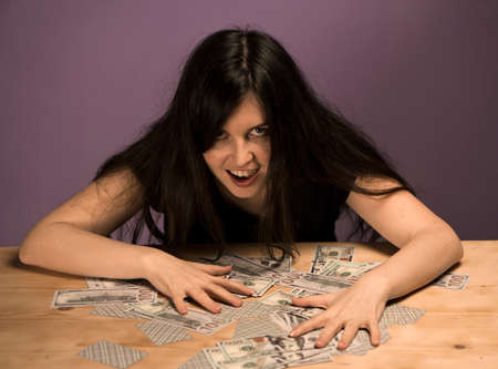 Young woman enjoys the money. Woman shouts of joy, because she won a large sum of money.