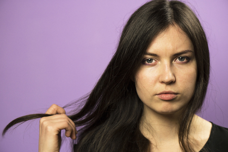 Portrait of a Charming Brunette girl on a Purple Backgroundの写真素材