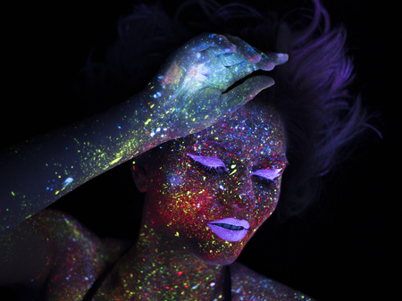 Portrait of Beautiful Fashion Woman in Neon UF Light. Model Girl with Fluorescent Creative Psychedelic MakeUp, Art Design of Female Disco Dancer Model in UVの写真素材