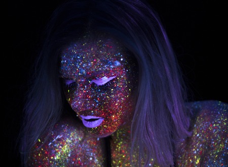 Portrait of Beautiful Fashion Woman in Neon UF Light. Model Girl with Fluorescent Creative Psychedelic MakeUp, Art Design of Female Disco Dancer Model in UVの写真素材