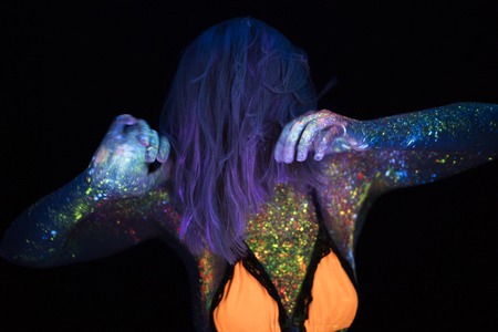 Portrait of Beautiful Fashion Woman in Neon UF Light. Model Girl with Fluorescent Creative Psychedelic MakeUp, Art Design of Female Disco Dancer Model in UVの写真素材