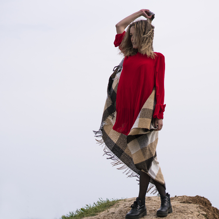 Happy Young Woman in Red Dress Have Fun at the Sea Coast Cliffの写真素材