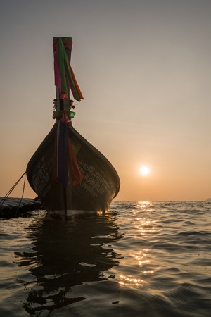 Sunset with silhouette of Traditional Longtail boat in the sea. Thailandの写真素材