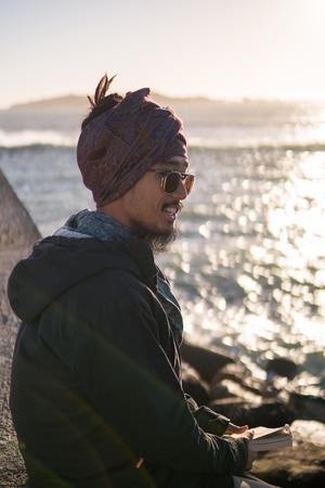 Young Asian Bearded Tourist man with Dreadlocks and scarf on head Enjoying Essaouira, Morocco at the...