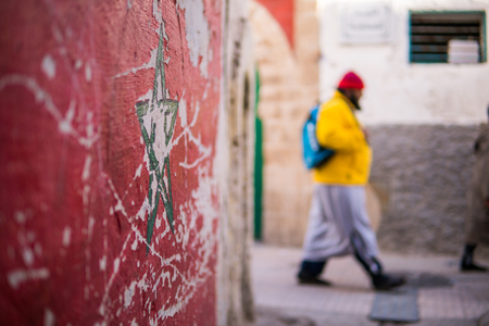 Green star flag of Morocco on street wall in Essaouira Medina