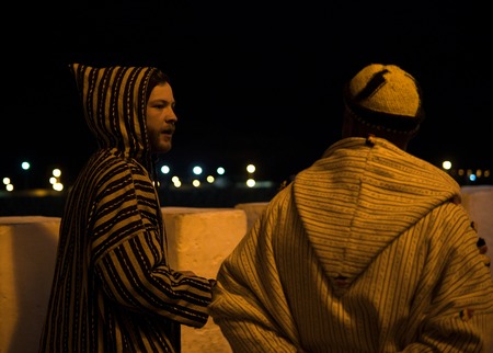 Two Man in Traditional moroccan djellaba walking on the street of Asilah Medina, on Atlantic Coast...