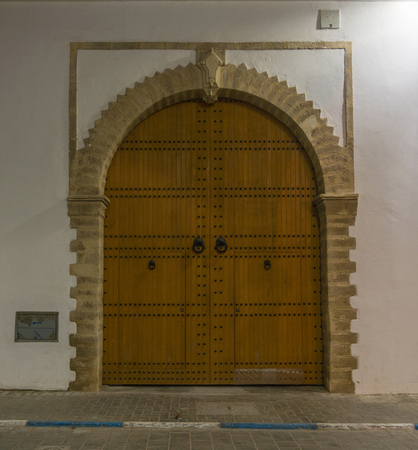 Old big Wooden Historical door on street of Essaouira City, Moroccoの写真素材