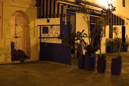 Man in Traditional moroccan djellaba walking on the street of Asilah Medina, on Atlantic Coast in Moroccoの写真素材