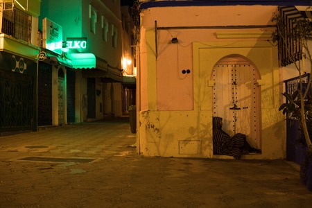 Man in Traditional moroccan djellaba walking on the street of Asilah Medina, on Atlantic Coast in Moroccoの写真素材
