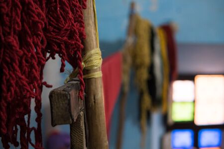 Old style tool for weaving a carpet with traditional techniques on a loom, in the privat family manufacture in Atlas mountains in Tinghir, Moroccoの写真素材
