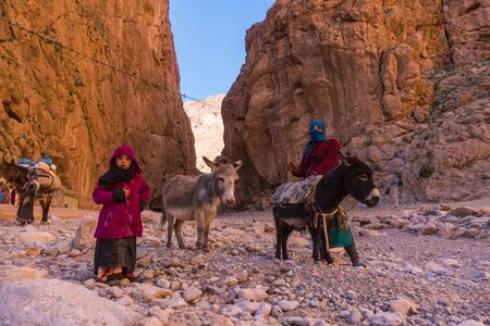 ATLAS MOUNTAINS, MOROCCO - 20 JAN: Nomad tribe people living in mountains near Tinghir or Tinerhir. Woman with her daughters are herding donkeys in canyon near the river. Todra gorgeのeditorial素材