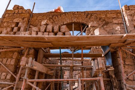 Building wall of Paving stones clay bricks, hand-made exposed to the sun to dry in Morocco