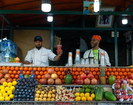 Marrakech, Morocco - 15 JAN 2019: Two happy arabic Fruit fresh juice sellers on Jemma El Fna square in Marrakesh, Moroccoのeditorial素材