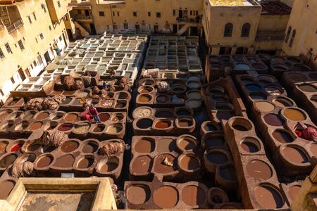 MOROCCO, FEX - January 2019: Workers in Chouara tannery in old medina in Fes, a traditional and old tannery with workers working making methods of leatherのeditorial素材