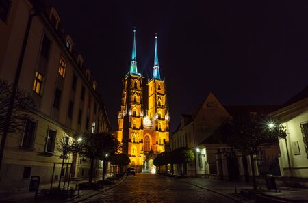 Wroclaw. View at night of the historical district Ostrow Tumski with the spires illuminated of the cathedral of St. John the Baptist.の写真素材