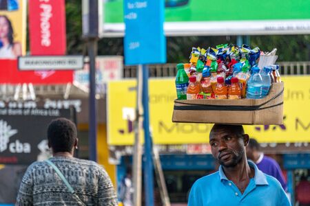 TANZANIA, ARUSHA - 15 Jan 2020: Carry good on the head is african skill. People on the street in Arusha city, Tanzaniaのeditorial素材
