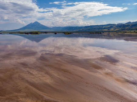 Aerial view on a Picturesque Coastline of Lake Natron in the Great Rift Valley, between Kenya and Tanzania. In the dry season the lake is 80% covered by soda and is known for its wading birds and huge flocks of flamingos.の写真素材