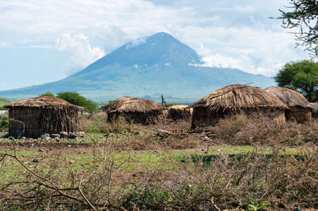 Traditional Maasai Village with Clay Round Huts in Engare Sero area near Lake Natron and Ol Doinyo Lengai volcano in Tanzania, Africaの写真素材