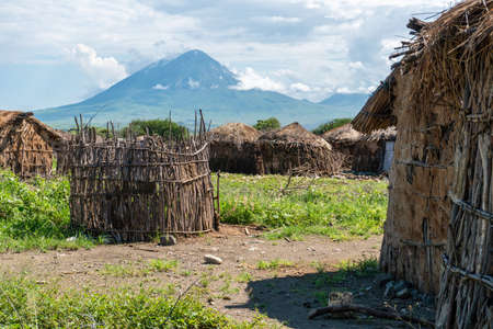 Traditional Maasai Village with Clay Round Huts in Engare Sero area near Lake Natron and Ol Doinyo Lengai volcano in Tanzania, Africaの写真素材